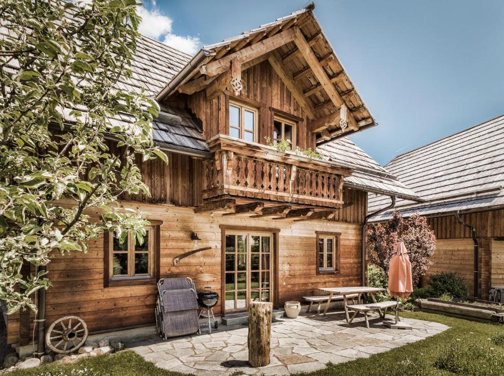 a log cabin with a deck and a patio at st martin chalets in Sankt Michael im Lungau