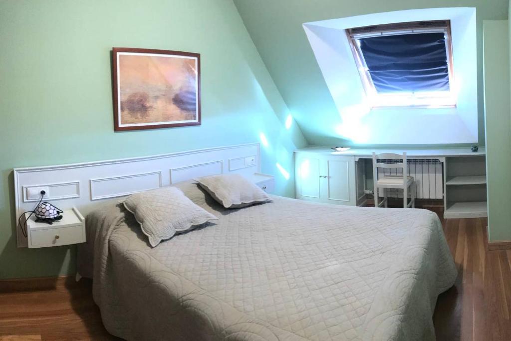 - une chambre dotée d'un lit avec un mur bleu dans l'établissement ATICO PINTOR ERNESTO GODAY, à O Grove