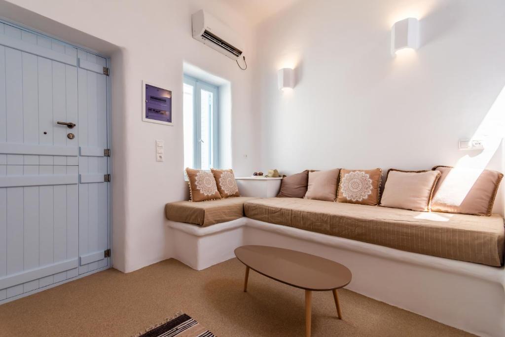 a living room with a couch and a table at Sunset Nest in Plaka Milou