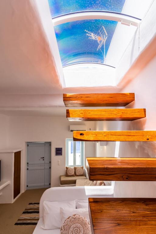 a skylight in a room with a bed and a ceiling at Sunset Nest in Plaka Milou