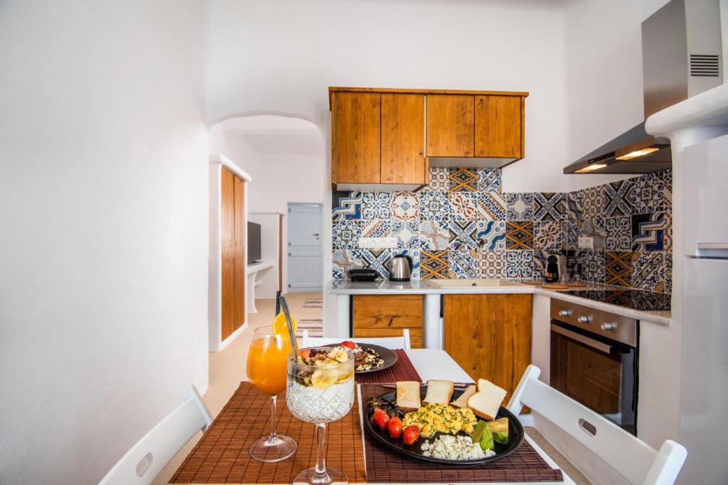 a kitchen with a table with a plate of food on it at Sunset Nest in Plaka Milou