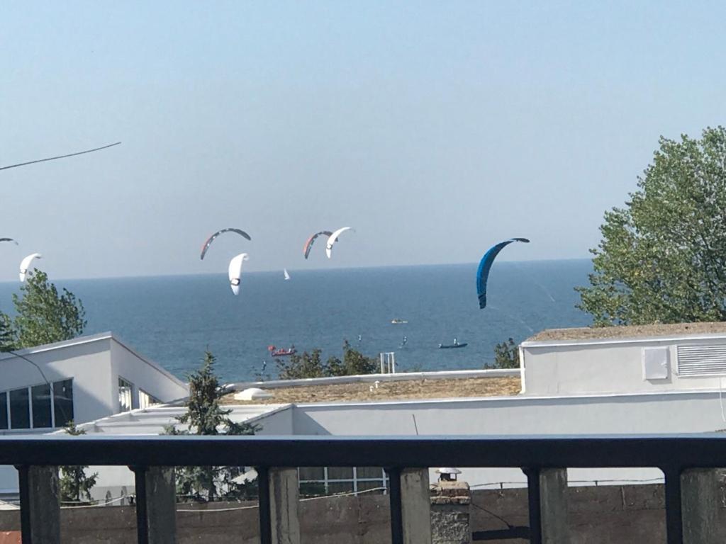 a group of kites flying in the sky over the ocean at Edel Exclusive Apartments Horyzont 414 Especially for You in Międzyzdroje