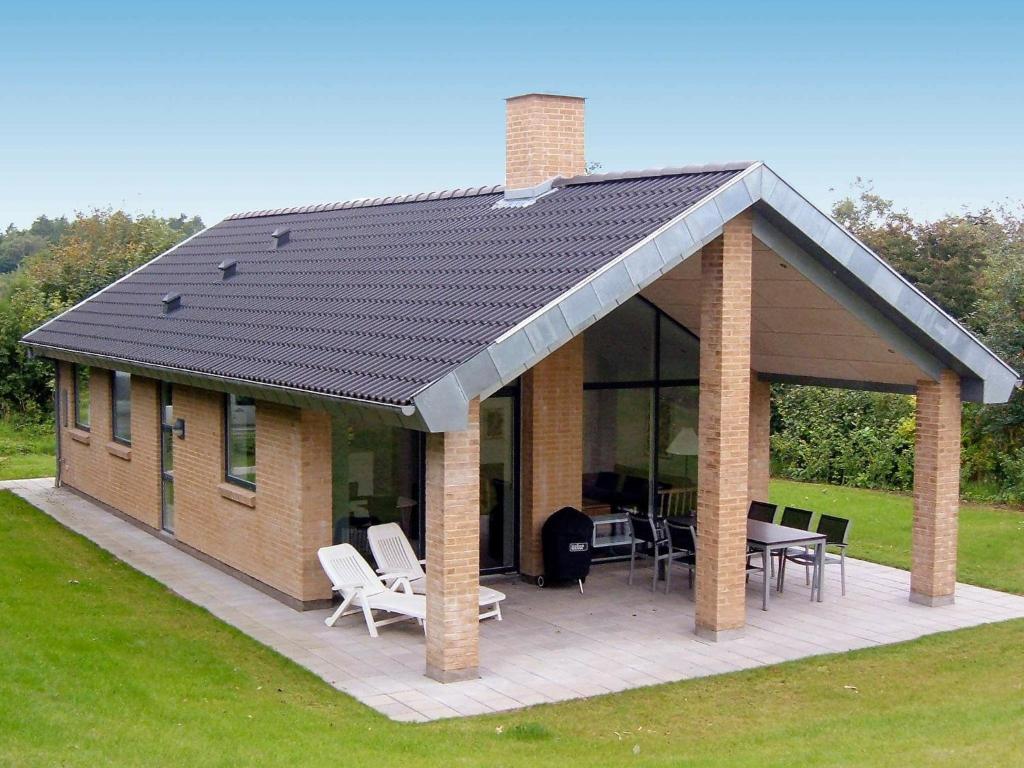 a pavilion with a table and chairs on a patio at Three-Bedroom Holiday home in Struer 5 in Remmer Strand