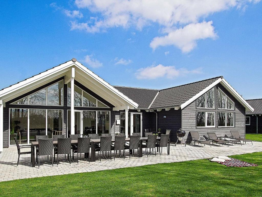 a house with a table and chairs in the yard at 16 person holiday home in Hasselberg in Kappeln