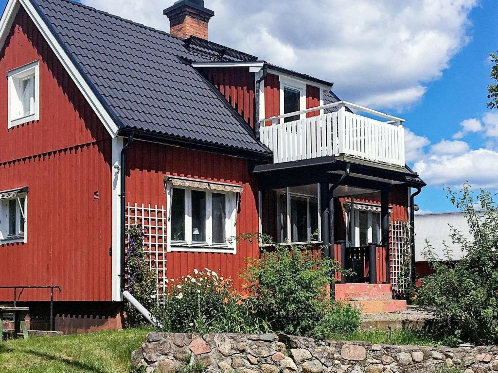 a red house with a black roof at 6 person holiday home in Berga in Berga