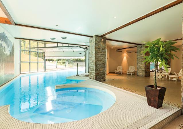 a large swimming pool in a large house at Appartement Cauterets in Cauterets