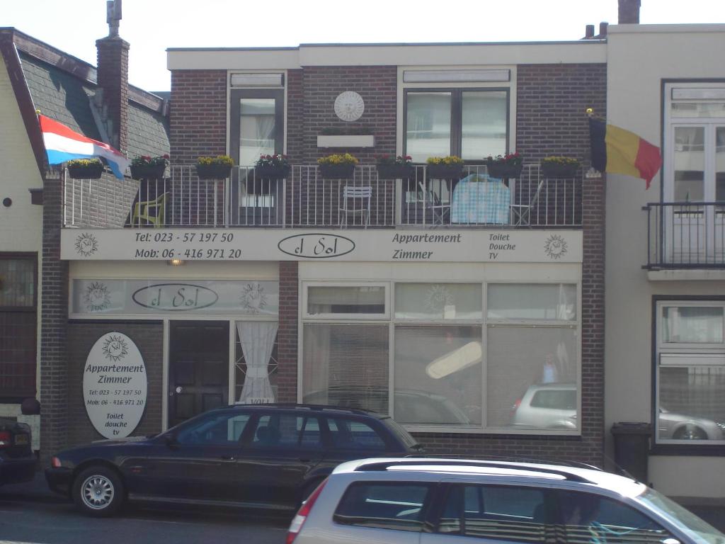 a building with a car parked in front of it at El Sol Zandvoort in Zandvoort