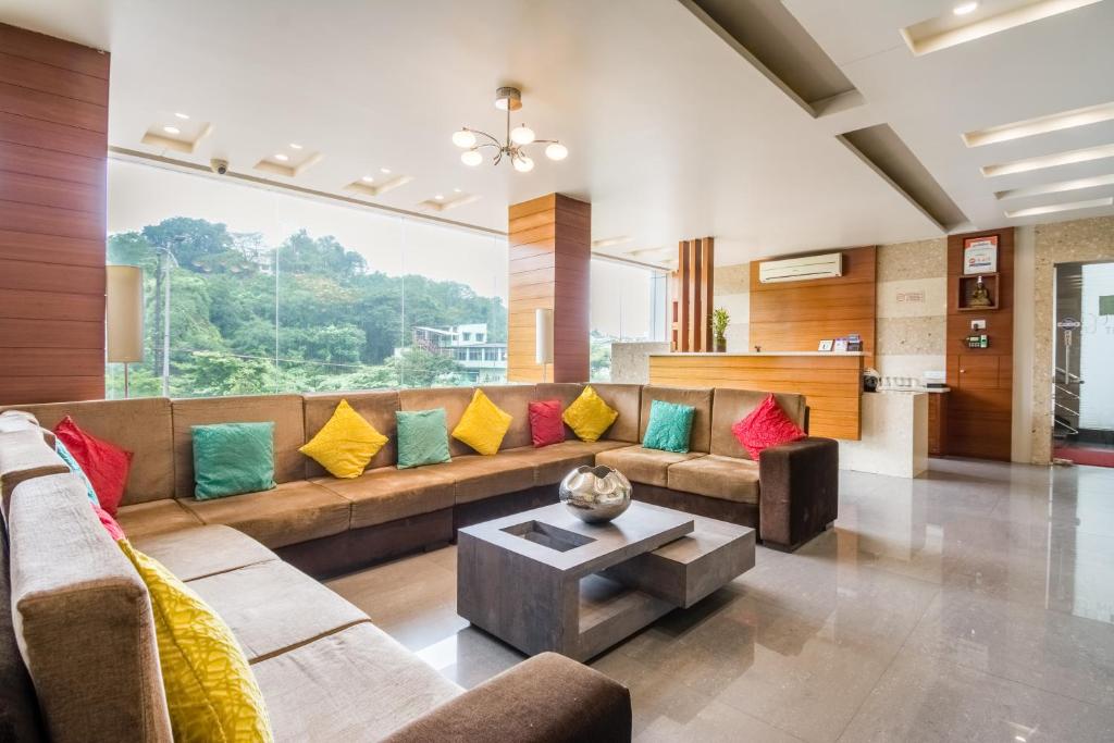 a living room with a couch with colorful pillows at Five Elements in Visakhapatnam