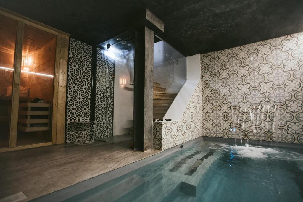 a bathroom with a swimming pool and a staircase at Castello Prime Suites in Lisbon