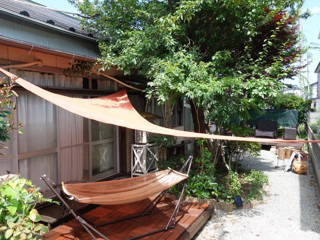 a hammock hanging outside of a house at コトのアート研究所 in Ishinomaki