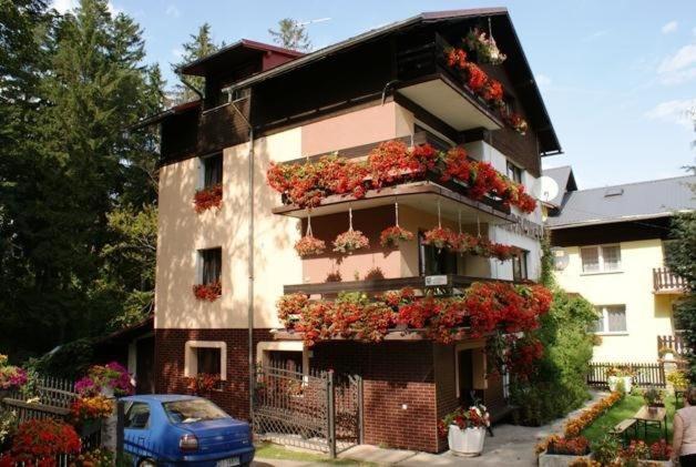 a building with flower boxes on the side of it at Willa Andromeda in Karpacz