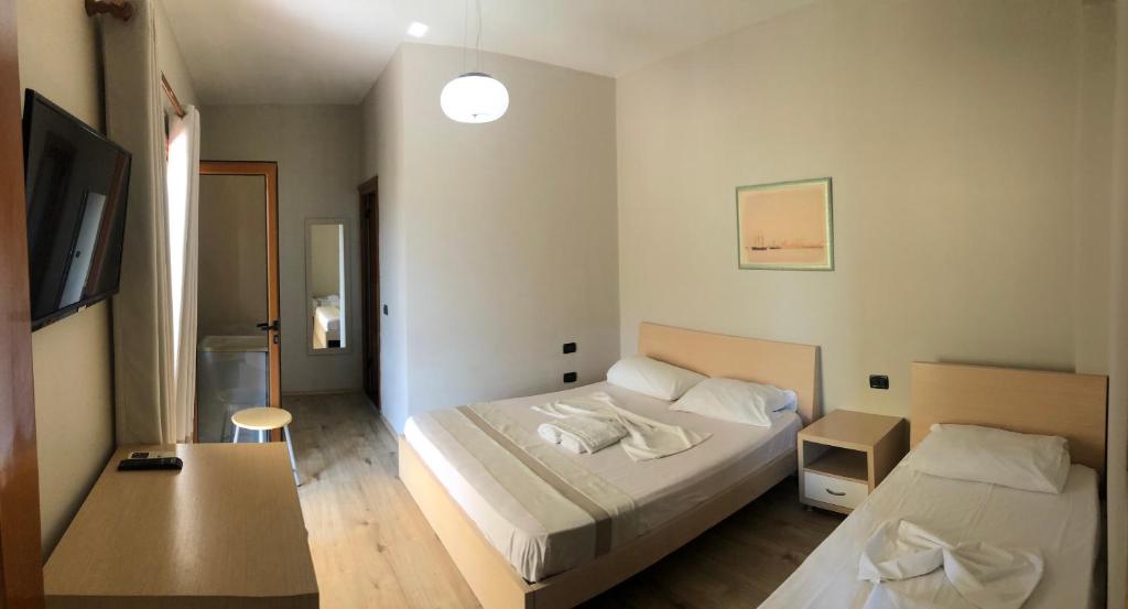 Postel nebo postele na pokoji v ubytování Hotel Denta