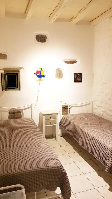 Posteľ alebo postele v izbe v ubytovaní Paros Sunset Villa