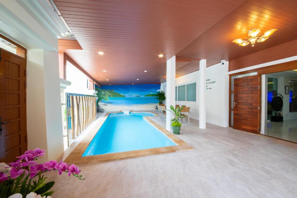 a swimming pool in the middle of a house at Rudi House in Patong Beach