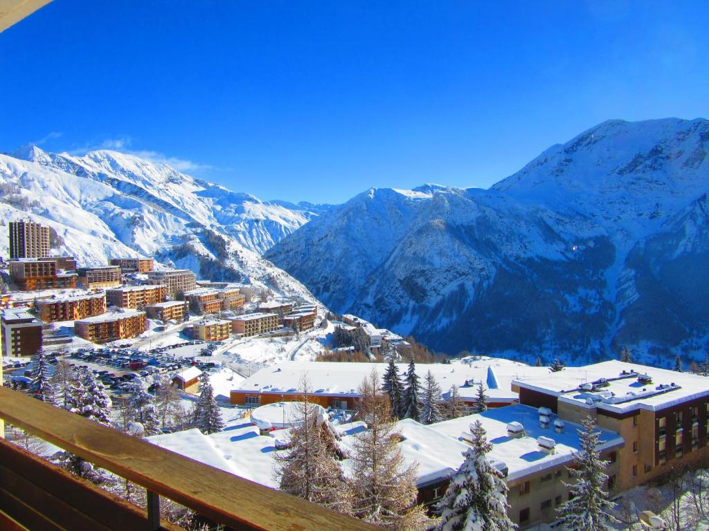 a view of a resort with snow covered mountains at Simonet Orcieres Merlette in Orcières