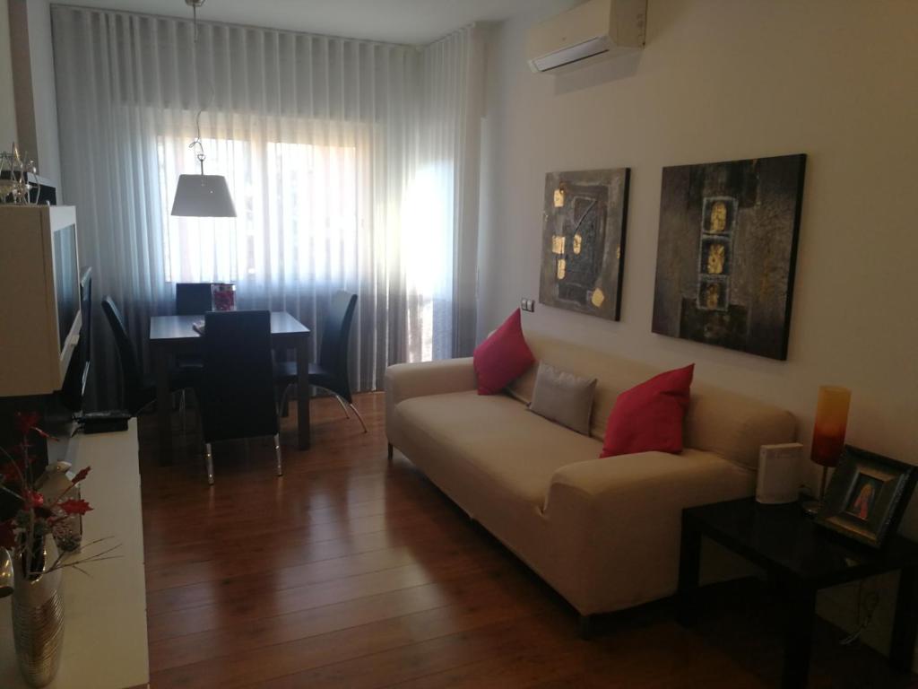 a living room with a couch and a table at Apartment Fira Barcelona Gran Via in Hospitalet de Llobregat