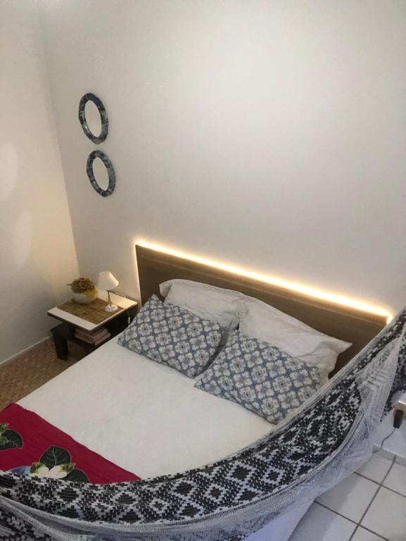 a bedroom with a bed with pillows on it at Apartamento na Praia in Fortaleza