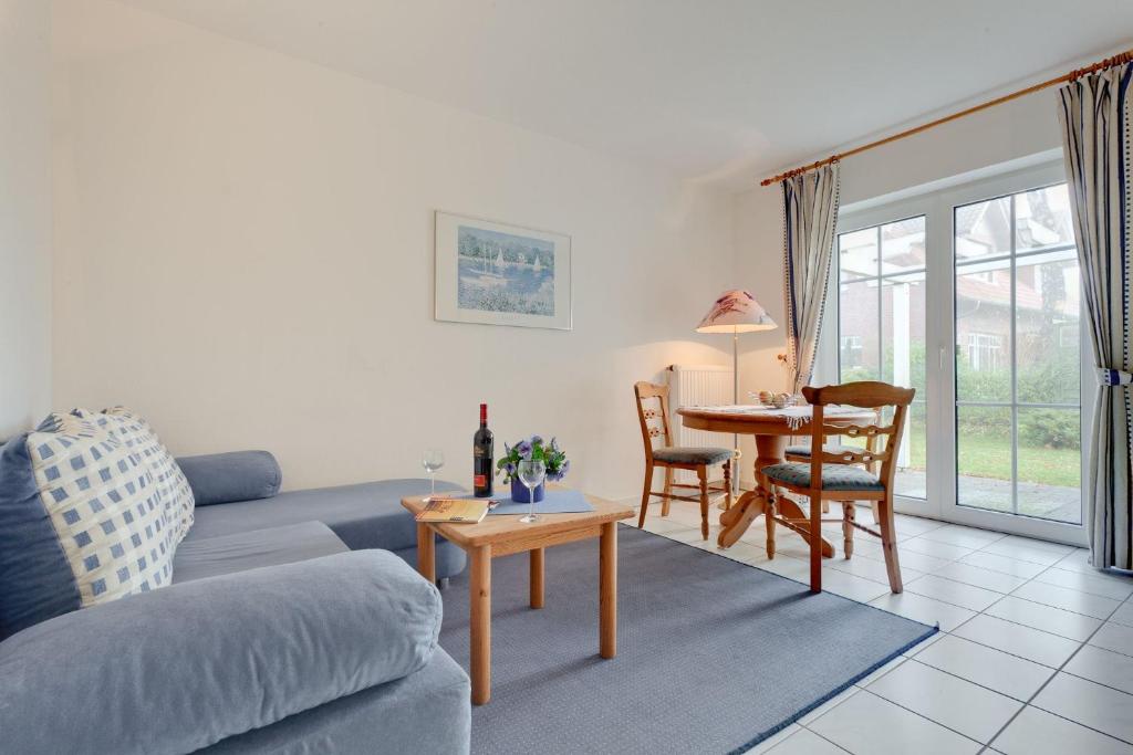 a living room with a couch and a table at Am Ostseestrand 1 in Zingst