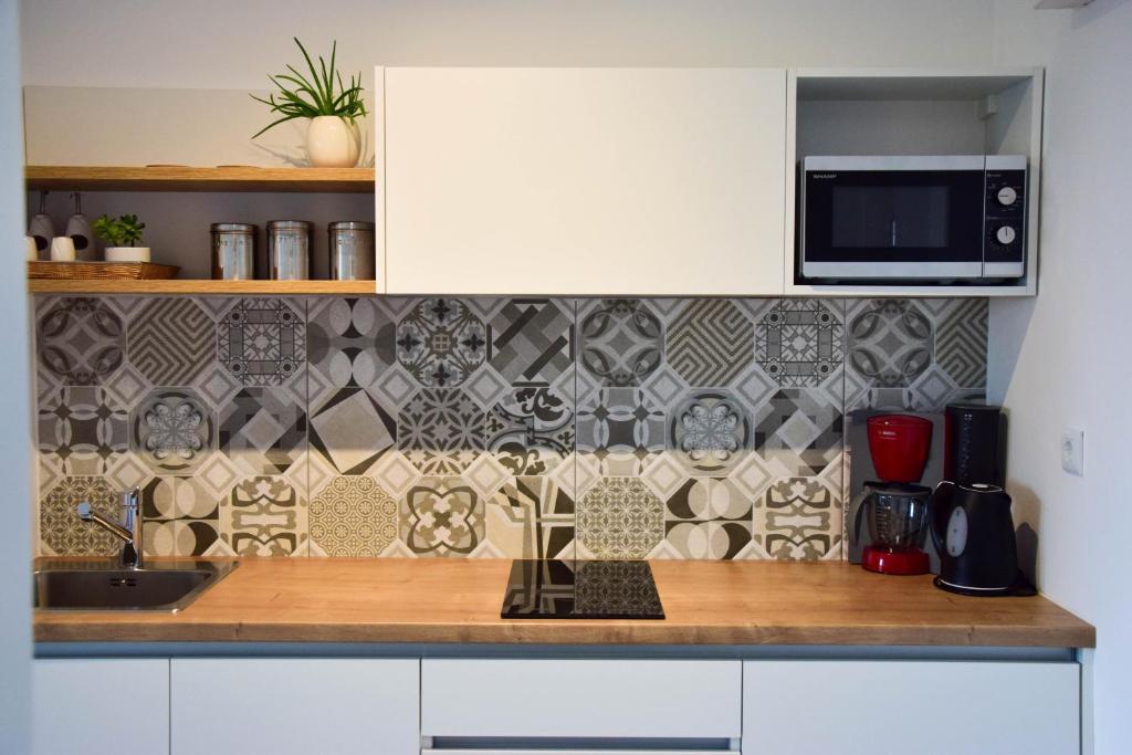a kitchen counter with a sink and a microwave at sky in Pula
