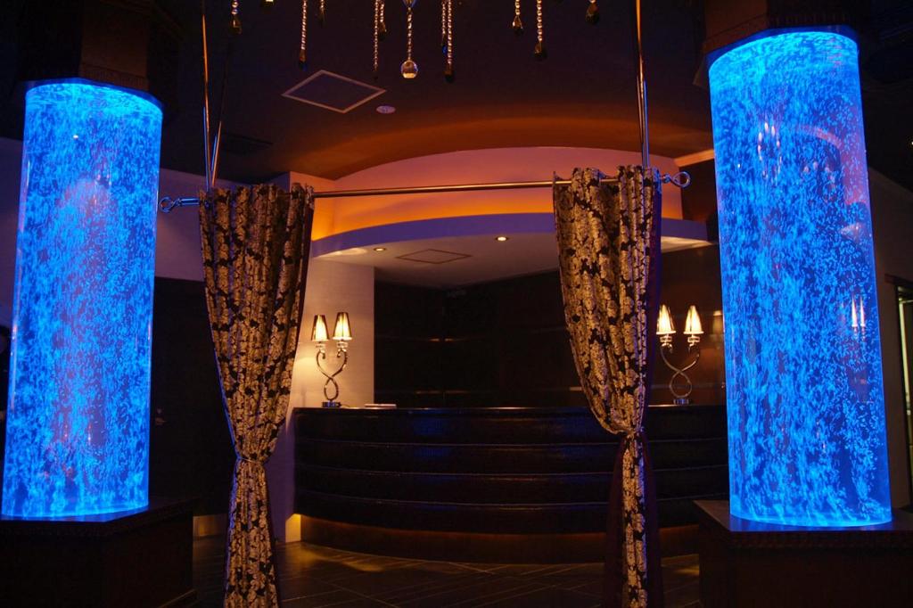 a set of blue lights in a room with stairs at Hotel MINT ( Adult Only) in Ikeda