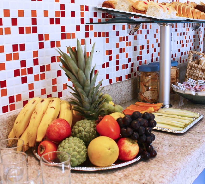 a bunch of fruits and vegetables on a counter at Hotel JB in São Mateus