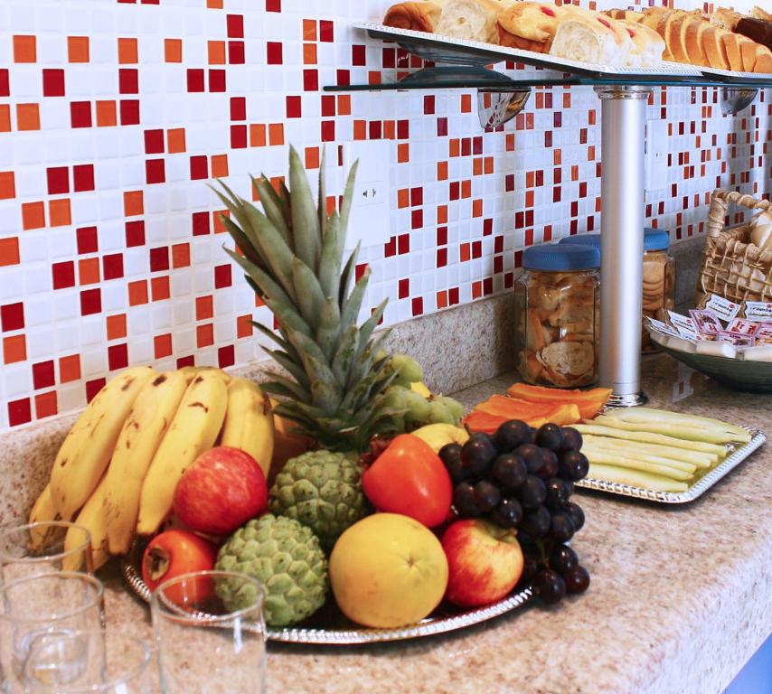 a table topped with lots of fruits and vegetables at Hotel JB in São Mateus