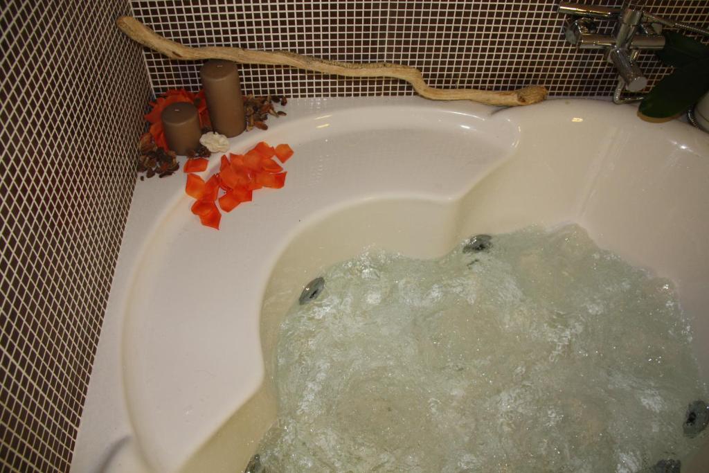 a bath tub filled with water with red peppers in it at NEW Bcomfort in Cagliari