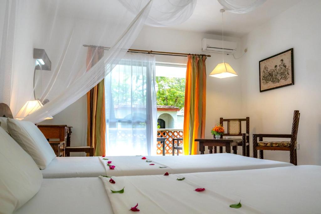 Postel nebo postele na pokoji v ubytování Diani Sea Lodge - All Inclusive
