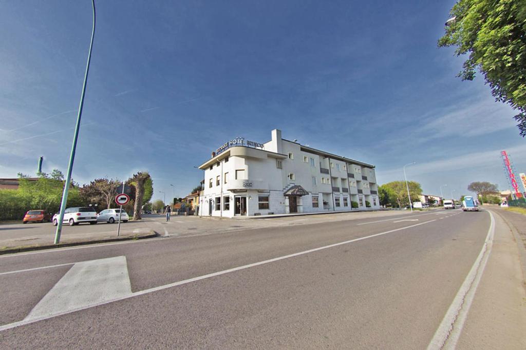 un edificio blanco al lado de una calle en Hotel Ristorante Brusco, en Caldiero