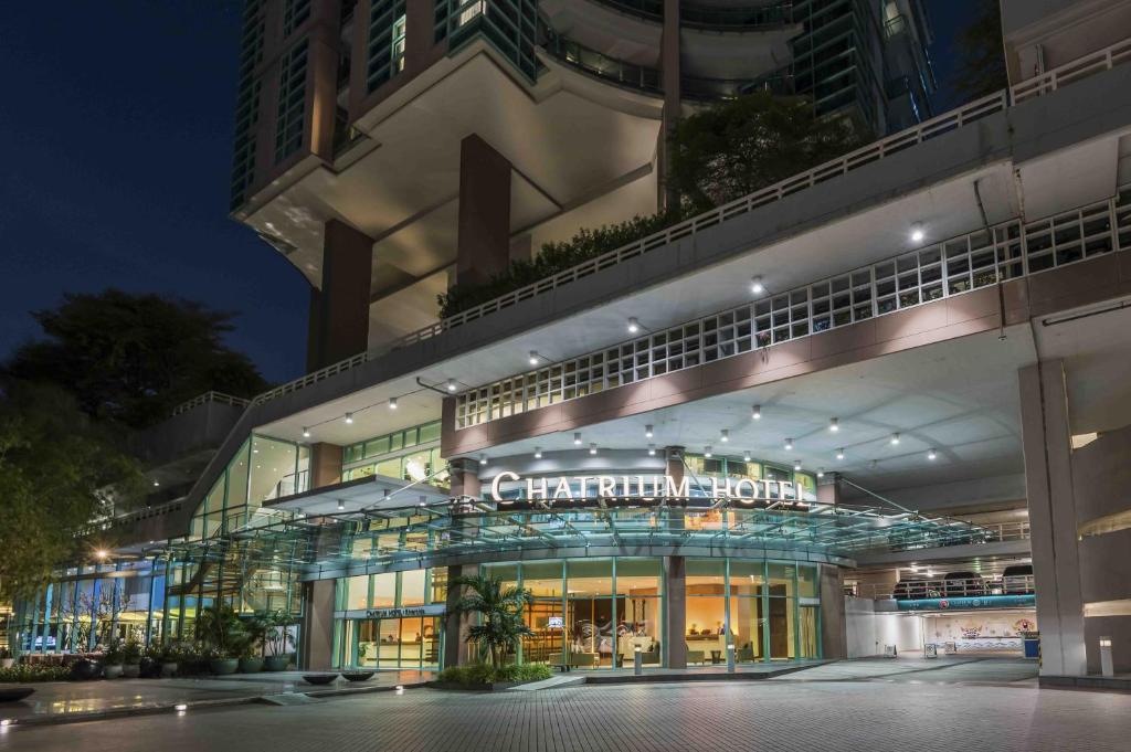 a building with a sign on the front of it at Chatrium Hotel Riverside Bangkok in Bangkok