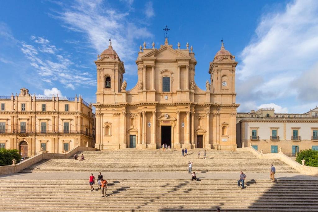 a large building with stairs in front of it at Casa Vico Lepre in Noto