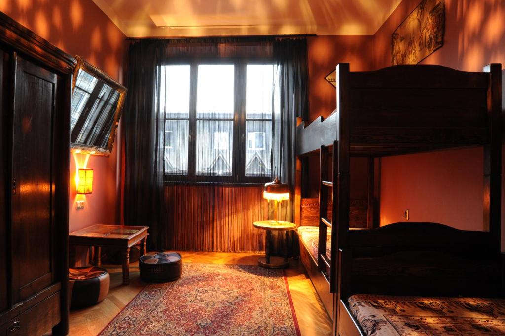 a bedroom with two bunk beds and a window at Hostel Deco in Krakow