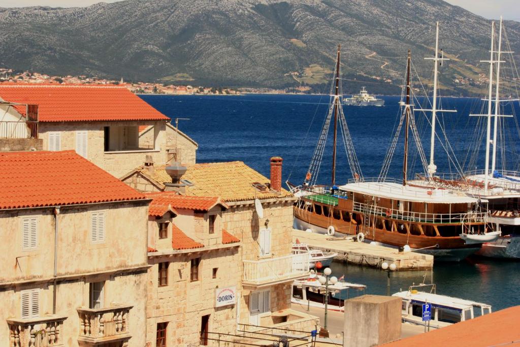 a group of boats docked in a harbor with buildings at Guest House Dijana in Korčula