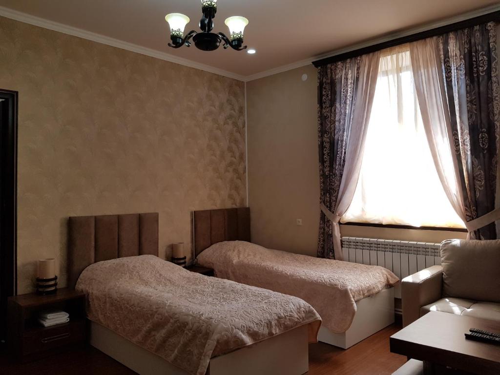 Postel nebo postele na pokoji v ubytování Ahana Hotel