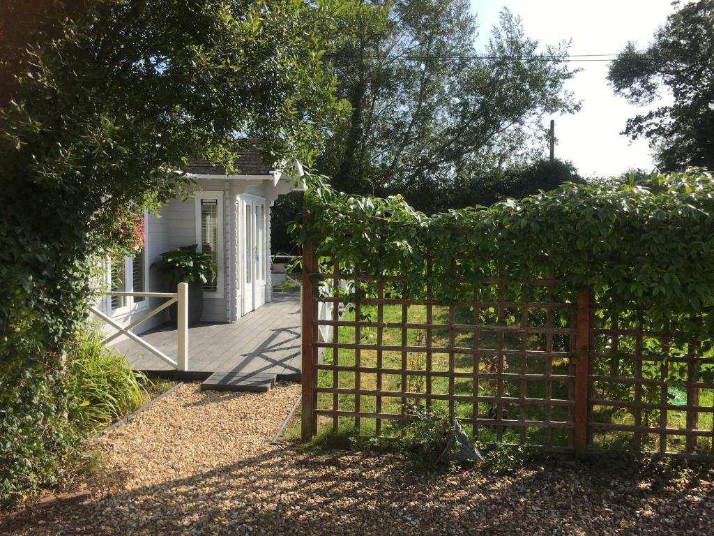 a gate in front of a white house at Willow House B&B in West Wittering