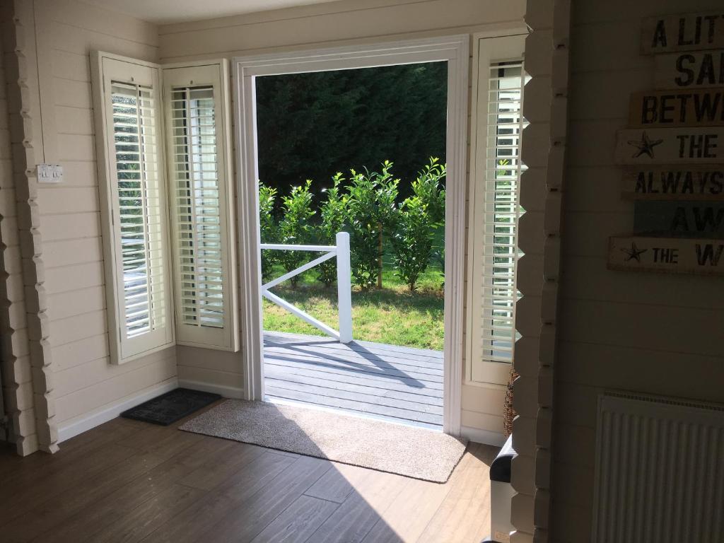 an open door leading to a porch with a gate at Willow House B&B in West Wittering