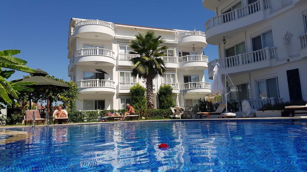 a hotel with a swimming pool in front of a building at BELKA GOLF RESIDENCE Exclusive apt DeluxBELEK in Belek