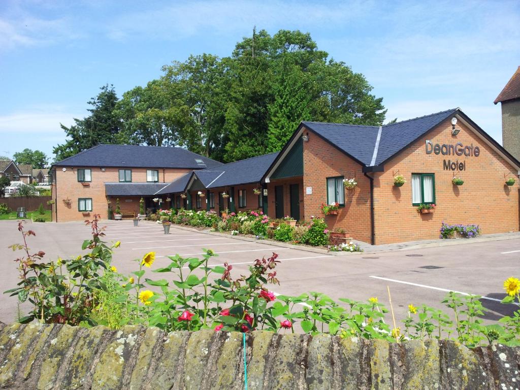 a row of buildings with a parking lot at Deangate Motel in Lydney