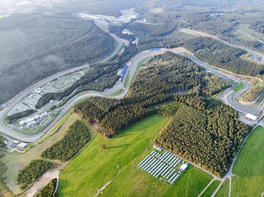 an aerial view of a river with trees and a road at GPtents-Spa-Francorchamps in Stavelot