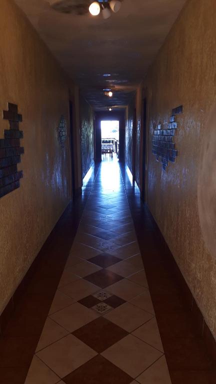 a hallway with a tile floor in a building at Czerwonki Apartament in Mrągowo