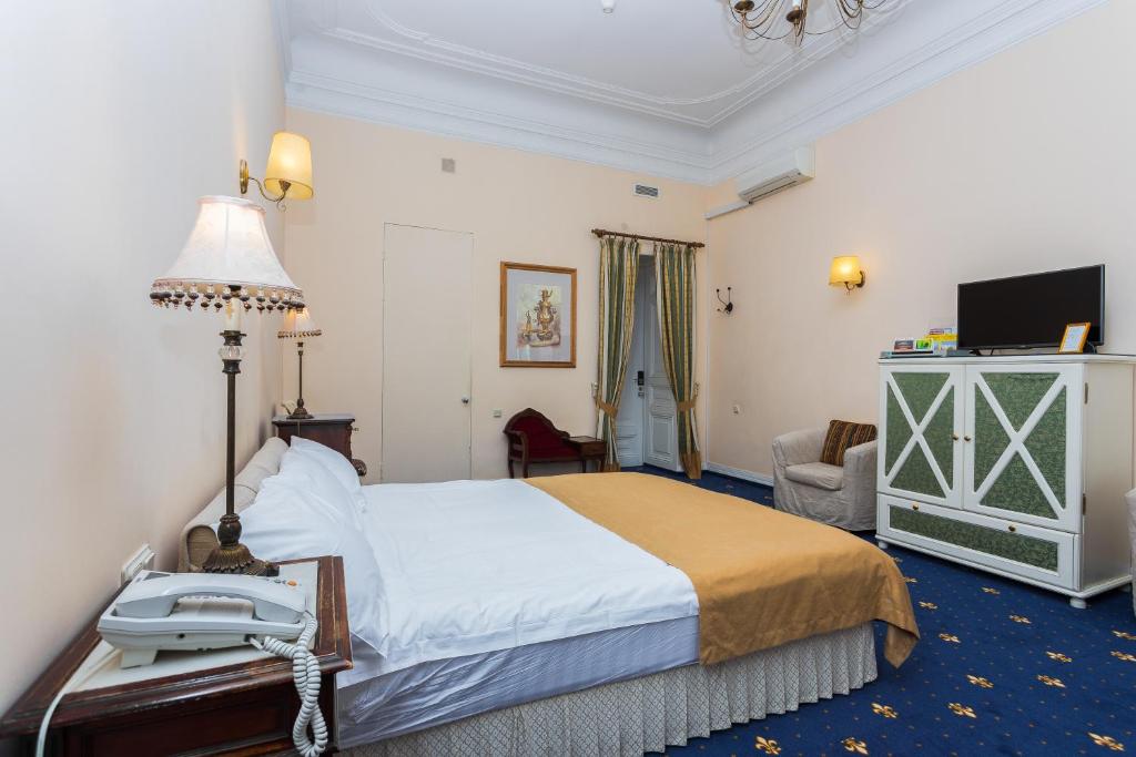a hotel room with a bed and a telephone in it at Casa Leto in Saint Petersburg