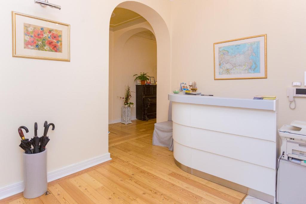 a kitchen with white walls and a counter with scissors at Casa Leto in Saint Petersburg