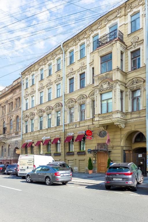 a large building with cars parked in front of it at Casa Leto in Saint Petersburg