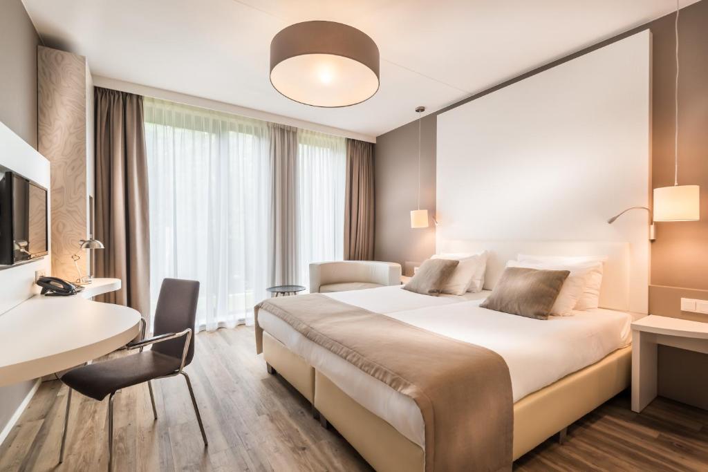 Postel nebo postele na pokoji v ubytování Fletcher Hotel-Restaurant de Wageningsche Berg
