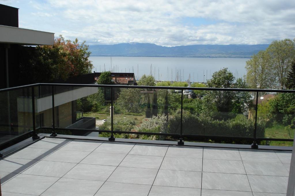 a balcony of a house with a view of the water at LEMAN in Thonon-les-Bains