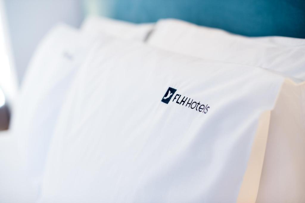 a white shirt with a fila logo on it at Reserva FLH Hotels Ericeira in Ericeira