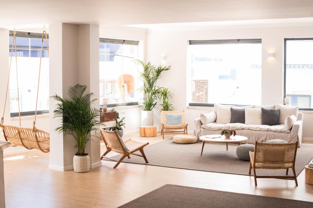 a living room with a couch and chairs at Reserva FLH Hotels Ericeira in Ericeira