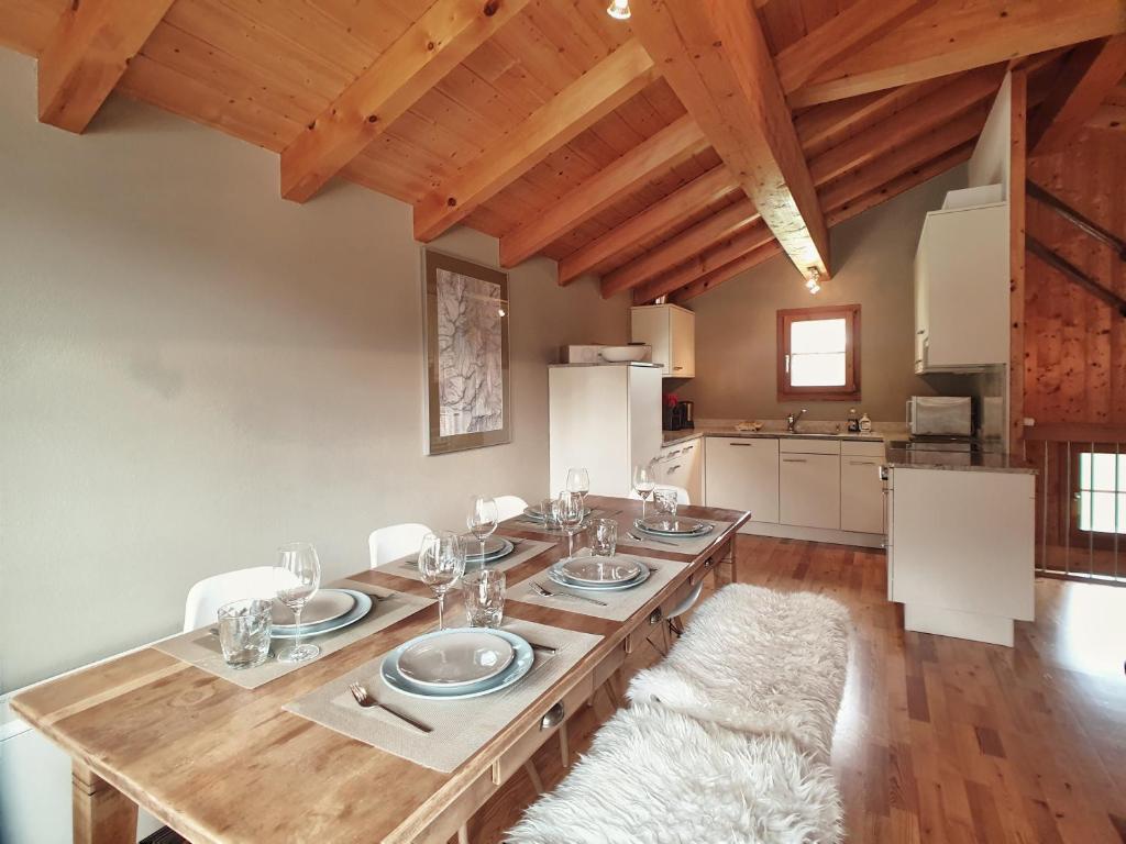 a dining room with a wooden table and chairs at Mountain Village Chalet in Saas-Fee