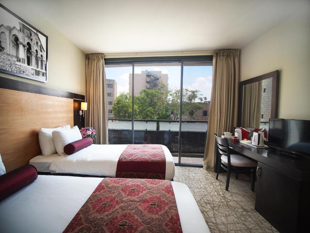 Postel nebo postele na pokoji v ubytování New Capitol Hotel - Jerusalem