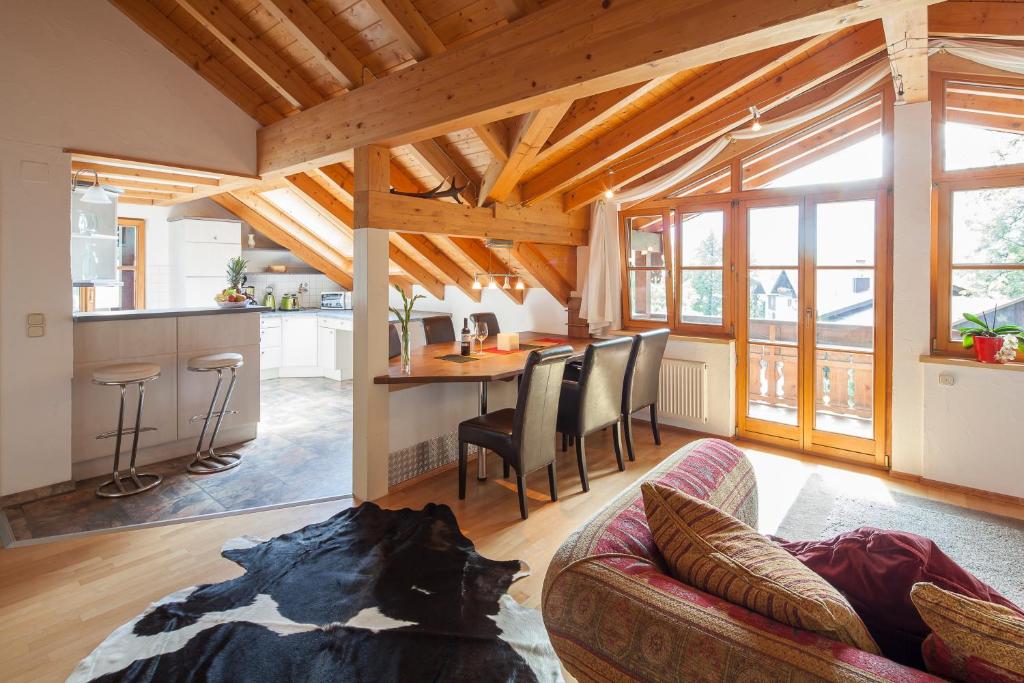 a dog laying on a couch in a living room at Ferienwohnungen Weidach in Oberstdorf